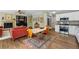 Open-concept layout features a kitchen, dining area, and cozy living room with a fireplace at 531 Americana Rd, Longmont, CO 80504