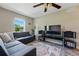 Relax in this living room, featuring a large window, plush seating, and modern entertainment center at 531 Americana Rd, Longmont, CO 80504