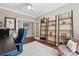 Home office with French doors, built-in shelving, and a comfortable seating area at 531 Americana Rd, Longmont, CO 80504