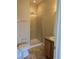 Tiled bathroom with glass door shower, exhaust fan, and oak vanity at 9578 Pearl Cir # 105, Parker, CO 80134