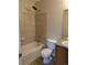 Cozy bathroom featuring a shower and bathtub combo with tiled walls and a sleek single sink vanity at 9578 Pearl Cir # 105, Parker, CO 80134