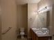 Traditional bathroom with double sinks, wood cabinets, and a tiled floor and backsplash at 9578 Pearl Cir # 105, Parker, CO 80134