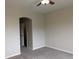 Neutral bedroom includes neutral carpet and an entry to an en-suite bathroom with closet at 9578 Pearl Cir # 105, Parker, CO 80134