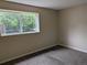 Bright bedroom featuring a large window offering natural light and views of lush greenery at 9578 Pearl Cir # 105, Parker, CO 80134