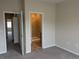 View from bedroom of the en-suite bath including glass shower, vanity, and open doorway at 9578 Pearl Cir # 105, Parker, CO 80134