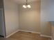 Simple dining room with hardwood floors and a chandelier, next to the kitchen area at 9578 Pearl Cir # 105, Parker, CO 80134
