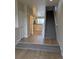 Bright entryway with hardwood floors, carpeted stairs, and a glimpse of the kitchen at 9578 Pearl Cir # 105, Parker, CO 80134