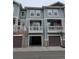Exterior view of townhome features balconies and attached garages with basketball hoop at 9578 Pearl Cir # 105, Parker, CO 80134