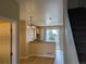 Bright kitchen with stainless steel appliances, and a breakfast bar near the staircase at 9578 Pearl Cir # 105, Parker, CO 80134
