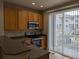 Well-equipped kitchen with modern appliances and a sliding glass door to the deck at 9578 Pearl Cir # 105, Parker, CO 80134