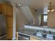 Galley style kitchen features breakfast bar, double sinks and modern dishwasher at 9578 Pearl Cir # 105, Parker, CO 80134