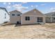 Exterior home view features a backyard with sliding glass doors and beige siding at 39171 Anthony St, Elizabeth, CO 80107