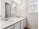 Well-lit bathroom showcasing a double vanity with modern chrome faucets and a large mirror at 39171 Anthony St, Elizabeth, CO 80107
