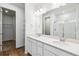 Bright bathroom featuring a double vanity with quartz countertops and a walk-in shower at 39171 Anthony St, Elizabeth, CO 80107