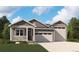 Charming single-story home featuring a two-car garage, inviting front porch, and well-maintained lawn at 39171 Anthony St, Elizabeth, CO 80107