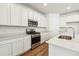 Modern kitchen featuring white cabinetry, stainless steel appliances, and light countertops at 39171 Anthony St, Elizabeth, CO 80107