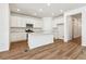 Spacious kitchen with stainless appliances, island with seating, and ample white cabinetry at 39171 Anthony St, Elizabeth, CO 80107