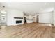 Spacious open floor plan with wood floors, fireplace, and modern kitchen at 39171 Anthony St, Elizabeth, CO 80107