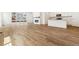 Open living room features wood flooring, fireplace, and sliding glass doors to backyard at 39171 Anthony St, Elizabeth, CO 80107