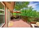 Inviting back deck with outdoor seating, an umbrella, and beautiful views of the surrounding nature at 10224 W 68Th Way, Arvada, CO 80004