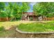 A well-maintained backyard featuring a lush lawn, stone accents, and access to the deck and lower level at 10224 W 68Th Way, Arvada, CO 80004