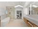 Modern bathroom with dual vanities, soaking tub, glass shower, and elegant finishes at 318 Adams St, Denver, CO 80206