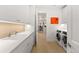 Bright laundry room with white cabinets, countertops, stainless steel sink, and modern washer and dryer at 318 Adams St, Denver, CO 80206