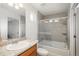 Bright bathroom features a shower-tub combo with glass doors, a vanity, and good lighting at 4431 N Quatar Ct, Aurora, CO 80019