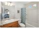 Well-lit bathroom features granite countertops and a combined shower and tub at 4431 N Quatar Ct, Aurora, CO 80019