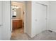 View from bedroom doorway to bathroom with white cabinets, vanity, and tiled floor at 4431 N Quatar Ct, Aurora, CO 80019