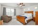 Bright bedroom features a cozy chair, a ceiling fan, and a large window at 4431 N Quatar Ct, Aurora, CO 80019