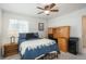 Comfortable bedroom with a ceiling fan, desk, and carpeted floor at 4431 N Quatar Ct, Aurora, CO 80019