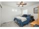 Cozy bedroom featuring a ceiling fan, carpet, and natural light from the windows at 4431 N Quatar Ct, Aurora, CO 80019