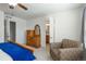 This is a bedroom with a reading chair, furniture, and an ensuite bathroom at 4431 N Quatar Ct, Aurora, CO 80019