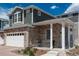 Beautiful two-story home with stone accents, covered porch and well-maintained landscaping at 4431 N Quatar Ct, Aurora, CO 80019