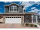 Charming two-story home showcasing a stone facade, two-car garage and inviting front porch at 4431 N Quatar Ct, Aurora, CO 80019
