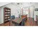 Inviting eat-in kitchen area with hardwood floors, granite island, and a charming bookcase at 4431 N Quatar Ct, Aurora, CO 80019