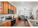Bright open kitchen with stainless appliances, granite countertops, and wood cabinets at 4431 N Quatar Ct, Aurora, CO 80019