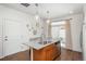 Open kitchen with granite island, stainless dishwasher, and access to outdoor space at 4431 N Quatar Ct, Aurora, CO 80019