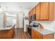 Well-equipped kitchen featuring granite counters, stainless steel appliances, and wood cabinetry at 4431 N Quatar Ct, Aurora, CO 80019