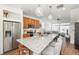 Spacious open-concept kitchen with granite island, stainless appliances, and view to living area at 4431 N Quatar Ct, Aurora, CO 80019