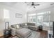Sunlit living room with vaulted ceiling, large windows, and stylish sectional sofa at 4431 N Quatar Ct, Aurora, CO 80019