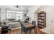 Bright living room boasts large windows, hardwood floors, and comfortable sectional sofa at 4431 N Quatar Ct, Aurora, CO 80019