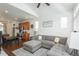 Open-concept living area features modern decor, a sectional sofa, and an eat-in kitchen at 4431 N Quatar Ct, Aurora, CO 80019