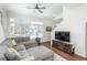 Cozy living room featuring hardwood floors, large windows, and a comfortable sectional sofa at 4431 N Quatar Ct, Aurora, CO 80019