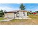 Back exterior view with a concrete patio and muted yellow paint at 598 S Navajo St, Denver, CO 80223