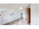 This is a bedroom with two windows, plank floors, white walls, and trim, plus an open, wooden door at 598 S Navajo St, Denver, CO 80223