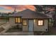Charming single-story home featuring a welcoming front door and well-lit windows against a colorful sunset backdrop at 598 S Navajo St, Denver, CO 80223