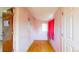 Pink hallway with wood floors and a window at 598 S Navajo St, Denver, CO 80223