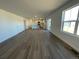 Open-concept living room with wooden floors that integrates with the modern kitchen at 22035 E 39Th Ave, Aurora, CO 80019